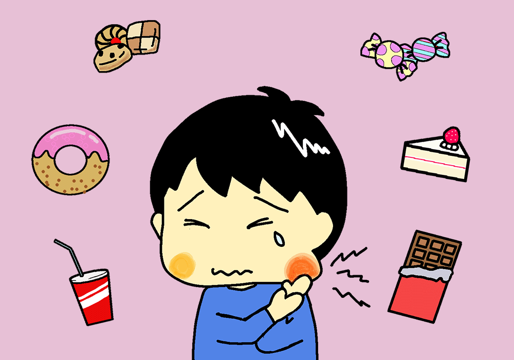 甘いものを食べて歯が痛い男の子